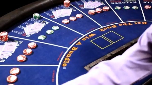 The dealer is spreading the cards as she delivers them The dealer is spreading the cards as she delivers them