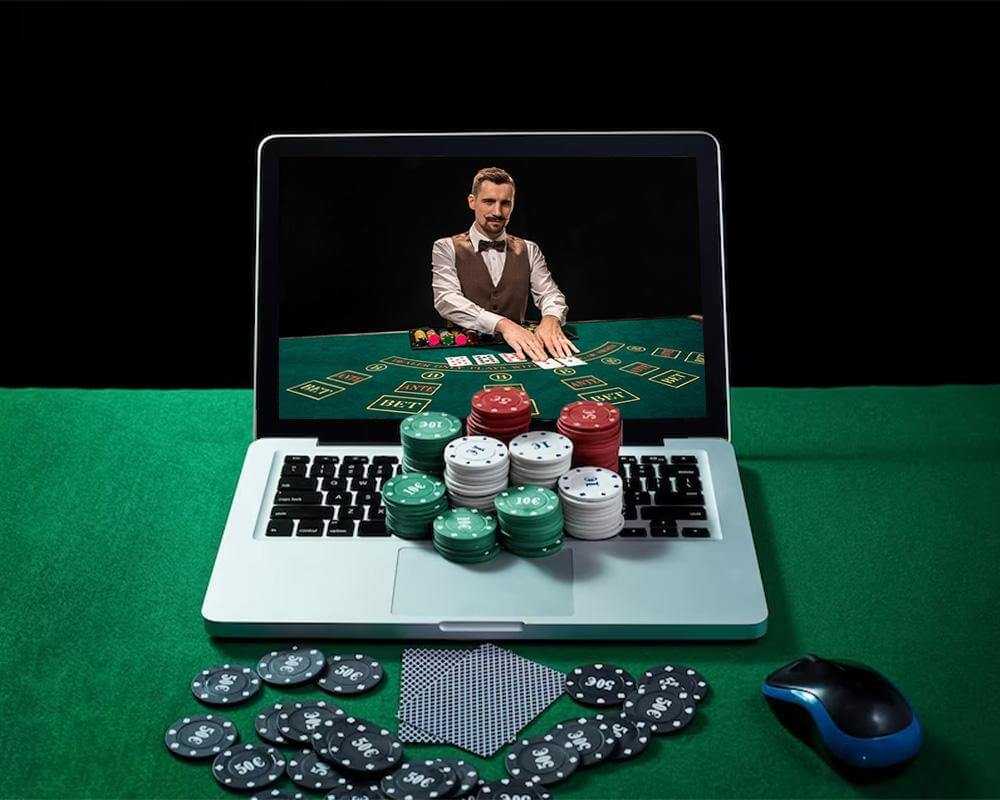 dealer in a laptop which has poker chips on it