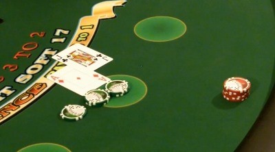 The dealer is hitting the players hand on a handheld deck The dealer is hitting the players hand on a handheld deck