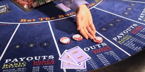The dealer is pushing the chips back to the player The dealer is pushing the chips back to the player