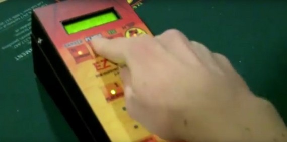 The dealer inputs the hand in the machine