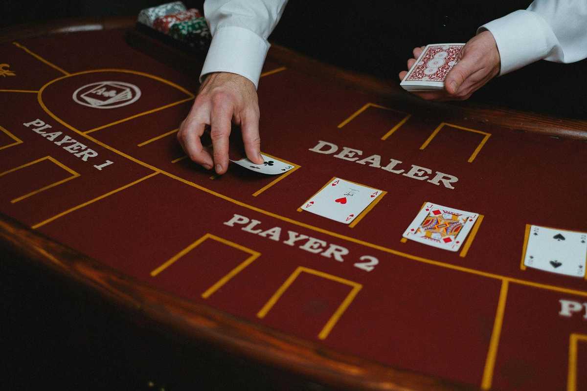 close up of blackjack table and croupier hands